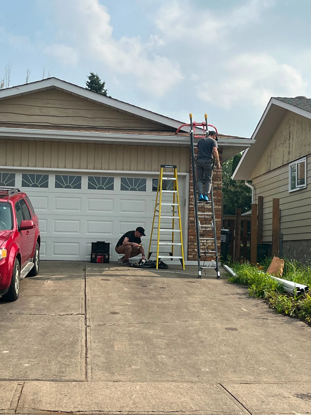 Re-Gutter crew performing repair work on a home
