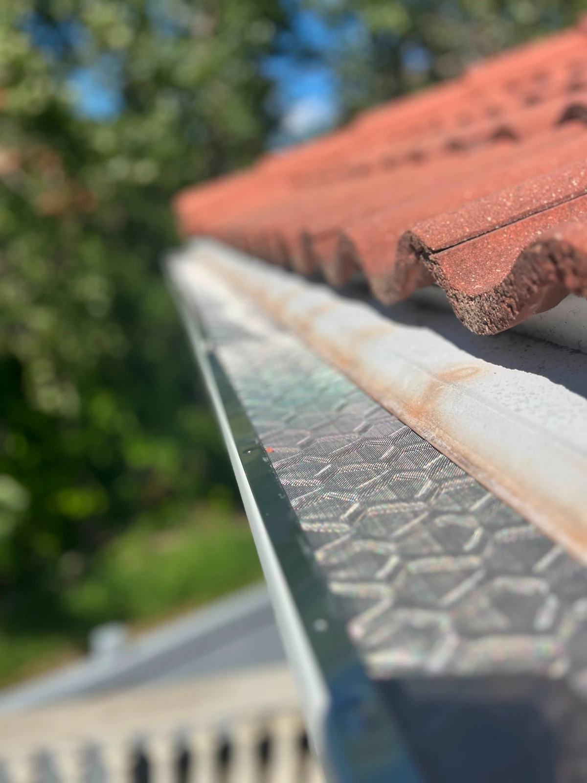 Close-up of black micro-mesh leaf guard material